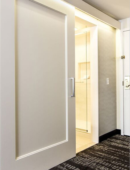 A white "barn door" in a hotel hallway