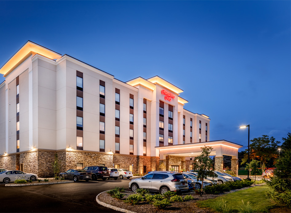 Large hotel building lit up at dusk